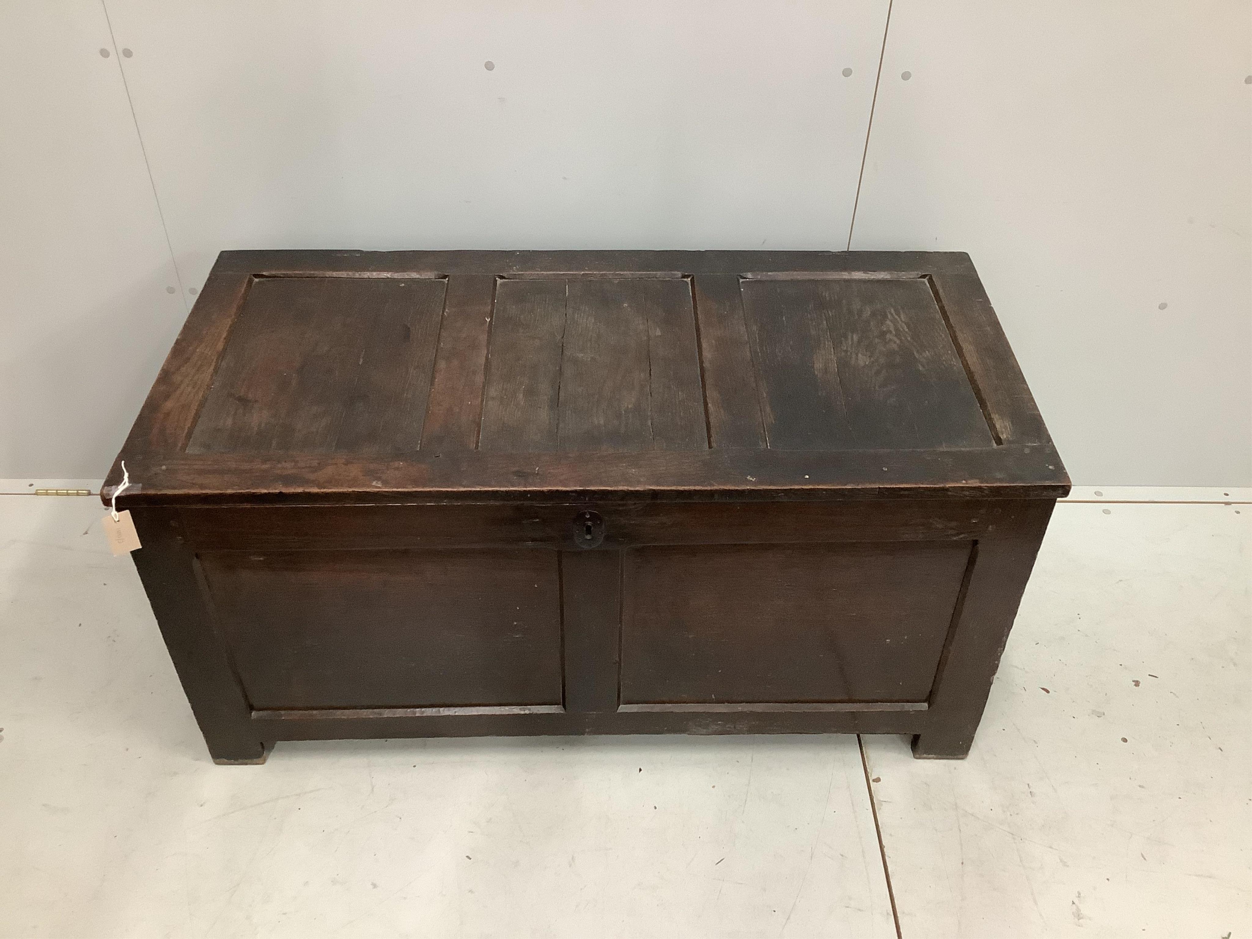 An early 18th century panelled oak coffer, width 126cm, height 62cm. Condition - fair to good, some splitting to the top panels